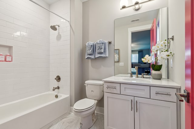 full bathroom featuring vanity, toilet, and tiled shower / bath