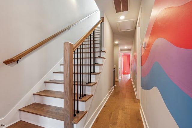 staircase featuring wood-type flooring