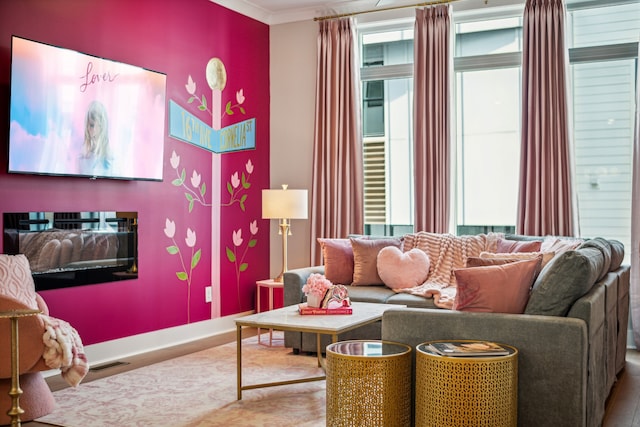 living room featuring wood-type flooring and crown molding