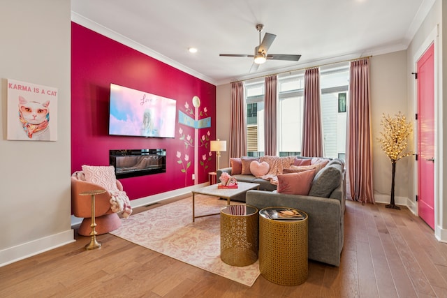 living room with hardwood / wood-style floors, ceiling fan, and crown molding