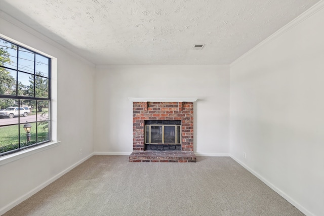 unfurnished living room featuring a textured ceiling, ornamental molding, a fireplace, and carpet flooring