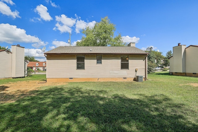 back of house with a lawn and central AC unit