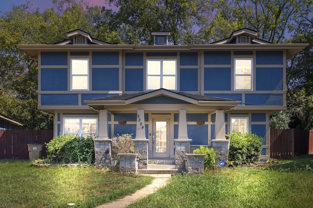 view of front of property with a front yard and a porch