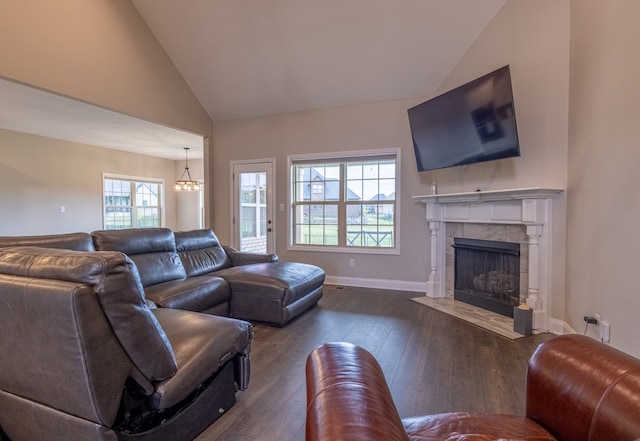 living room featuring a tiled fireplace, dark wood-type flooring, high vaulted ceiling, and a healthy amount of sunlight