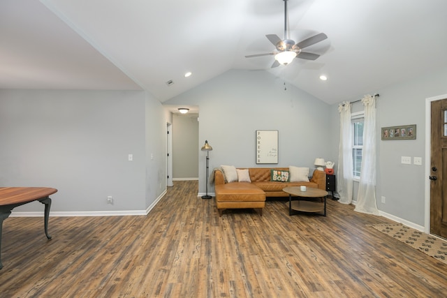 living area featuring vaulted ceiling, dark hardwood / wood-style floors, and ceiling fan