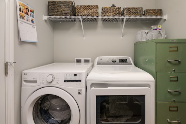 washroom featuring washing machine and dryer