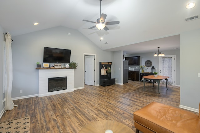 living room featuring ceiling fan with notable chandelier, lofted ceiling, and dark hardwood / wood-style floors