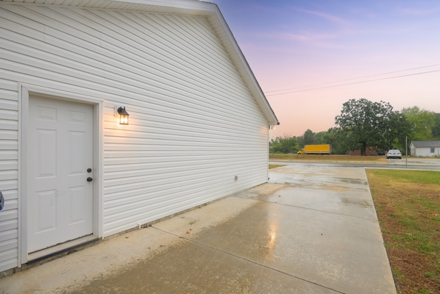 view of garage at dusk