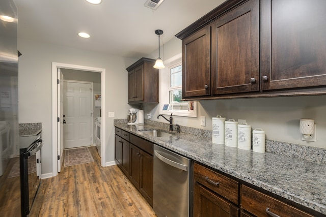 kitchen featuring hanging light fixtures, sink, stone counters, dishwasher, and hardwood / wood-style flooring