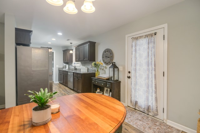 dining space with sink and light hardwood / wood-style flooring