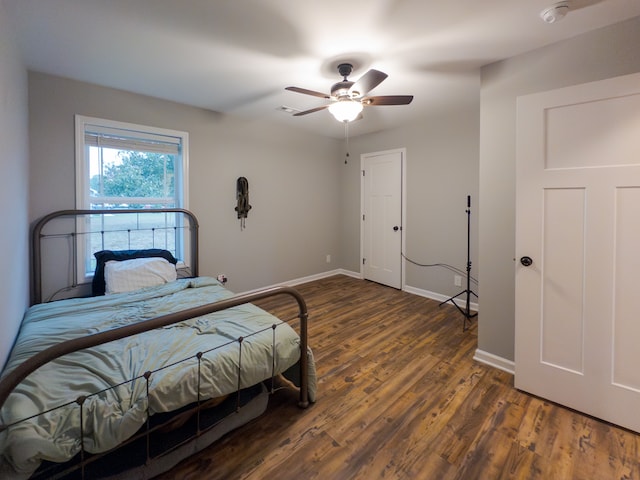 bedroom featuring ceiling fan and dark hardwood / wood-style flooring