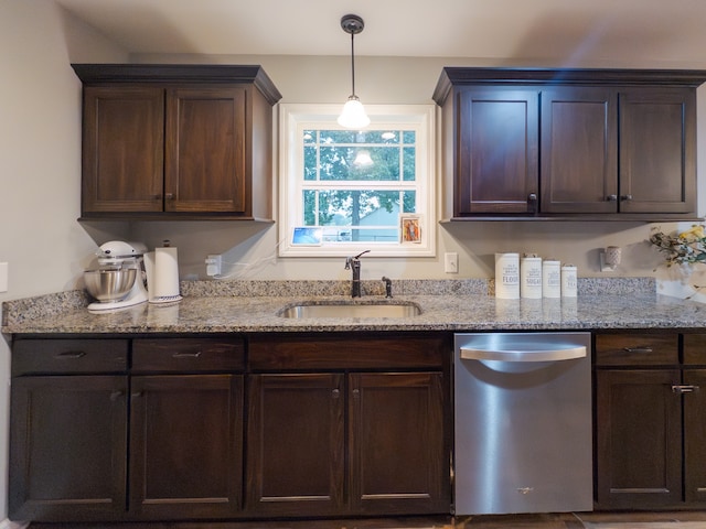 kitchen with light stone countertops, dark brown cabinets, sink, and stainless steel dishwasher