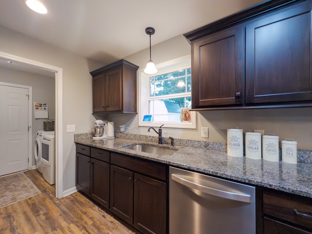 kitchen featuring dishwasher, sink, light hardwood / wood-style flooring, stone countertops, and washing machine and dryer