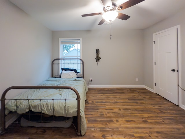 bedroom featuring ceiling fan and dark hardwood / wood-style flooring