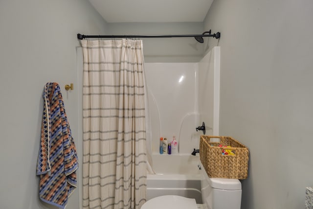 bathroom with shower / bath combo and toilet