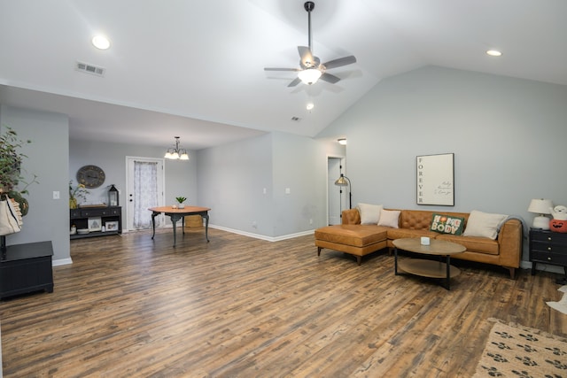 living room with ceiling fan with notable chandelier, dark hardwood / wood-style flooring, and lofted ceiling