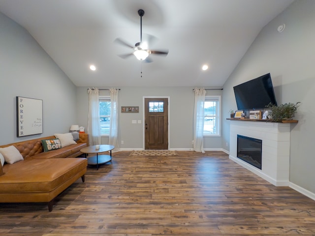 living room featuring lofted ceiling, dark hardwood / wood-style flooring, and ceiling fan