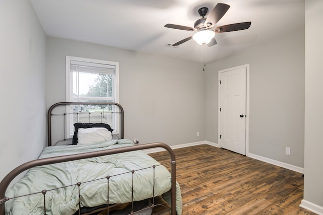 bedroom featuring ceiling fan and dark hardwood / wood-style floors