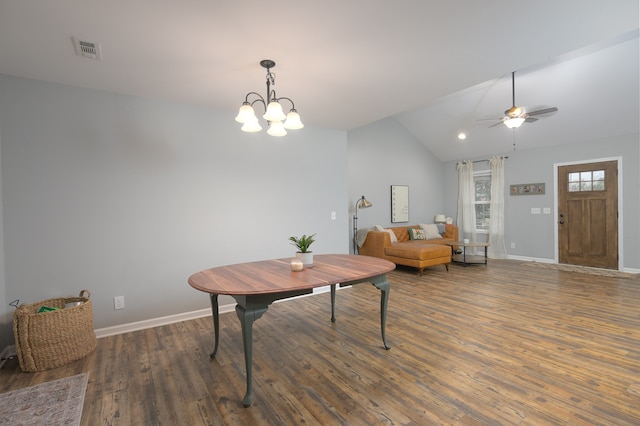 interior space with ceiling fan with notable chandelier, vaulted ceiling, and dark hardwood / wood-style floors