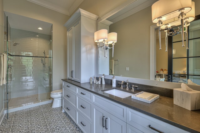 bathroom with vanity, ornamental molding, a shower with shower door, tile patterned floors, and toilet