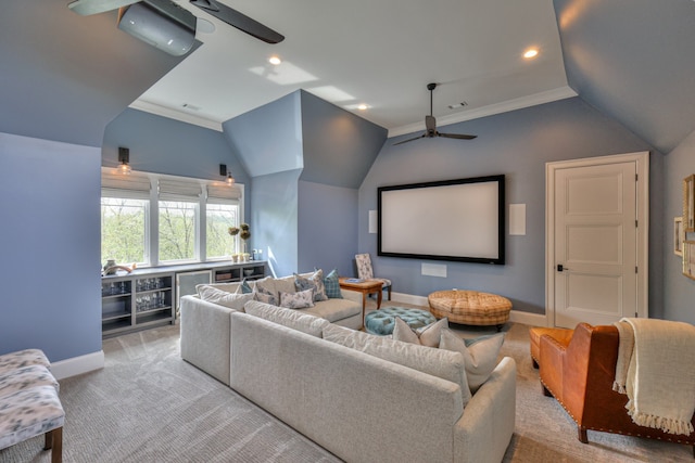 carpeted cinema featuring crown molding, vaulted ceiling, and ceiling fan