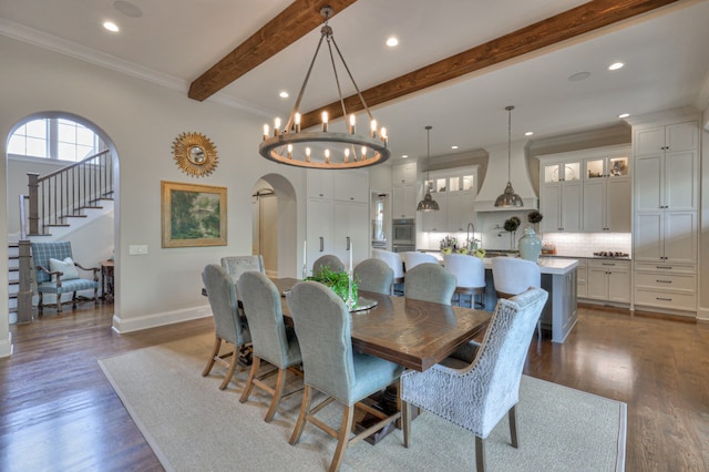 dining room featuring ornamental molding, beam ceiling, a chandelier, and dark wood-type flooring