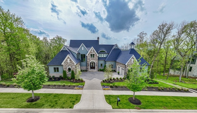 french country inspired facade featuring a front lawn