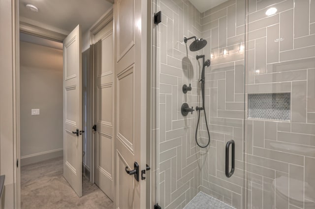 bathroom featuring a shower with door