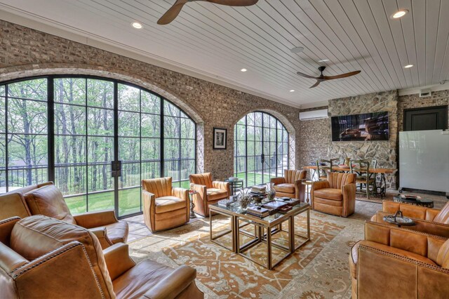 living room with wood ceiling, ceiling fan, and a wealth of natural light