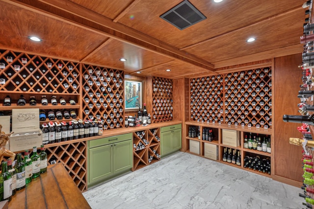 wine room featuring wood ceiling and beam ceiling