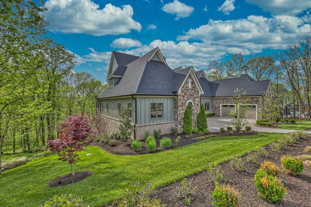 view of front of property featuring a garage and a front lawn