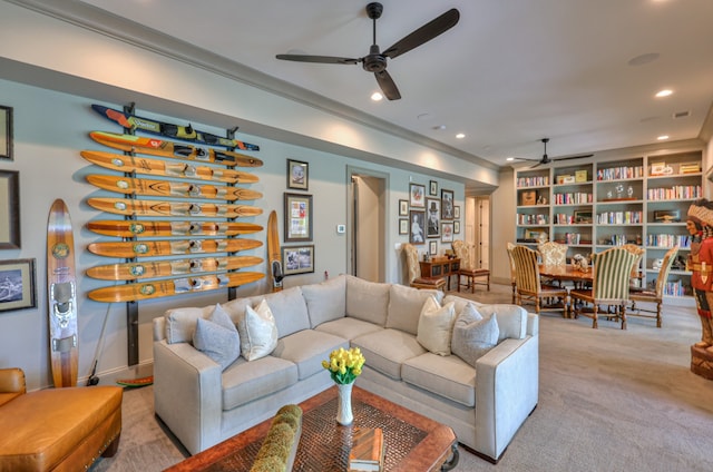 carpeted living room featuring ornamental molding and ceiling fan