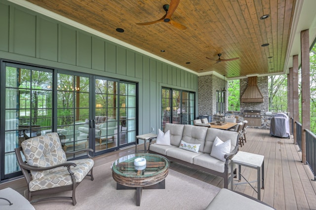 wooden deck with an outdoor living space, ceiling fan, and area for grilling