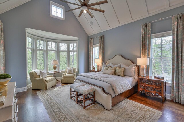 bedroom featuring multiple windows, dark hardwood / wood-style floors, and ceiling fan