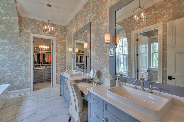 bathroom featuring vanity, crown molding, and a notable chandelier