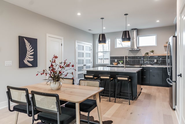 dining space with light wood-type flooring