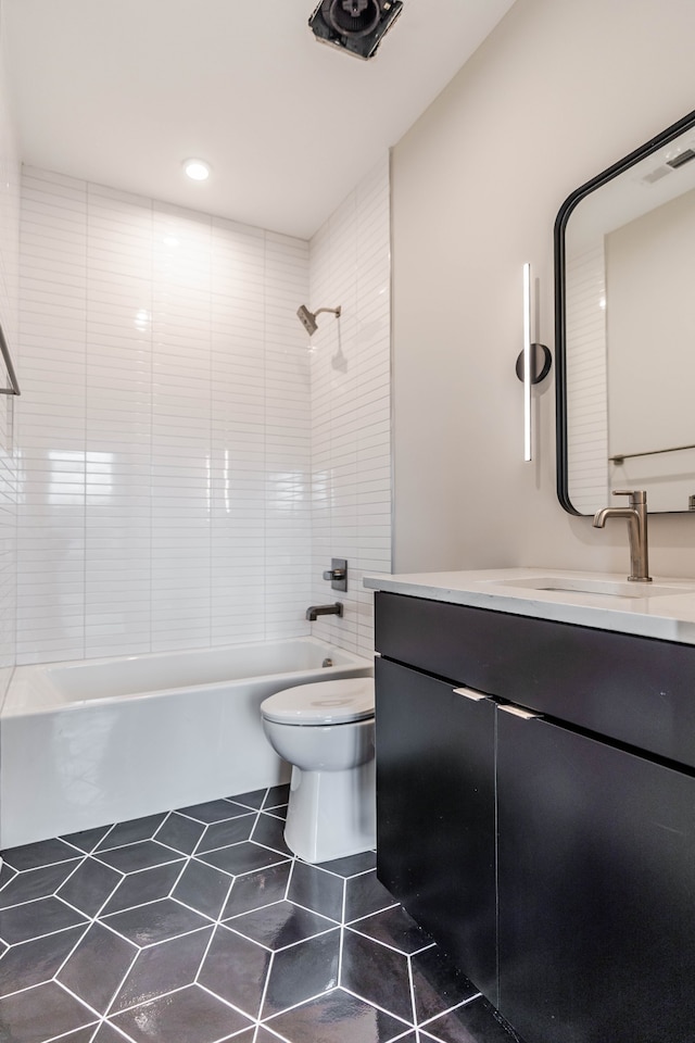 full bathroom with vanity, tiled shower / bath combo, toilet, and tile patterned floors