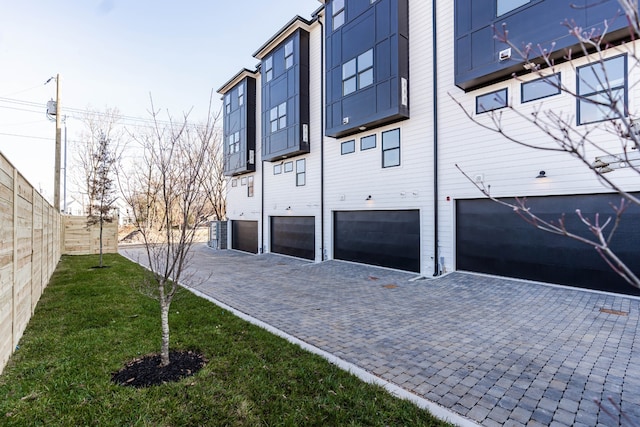 rear view of property with a yard and a garage