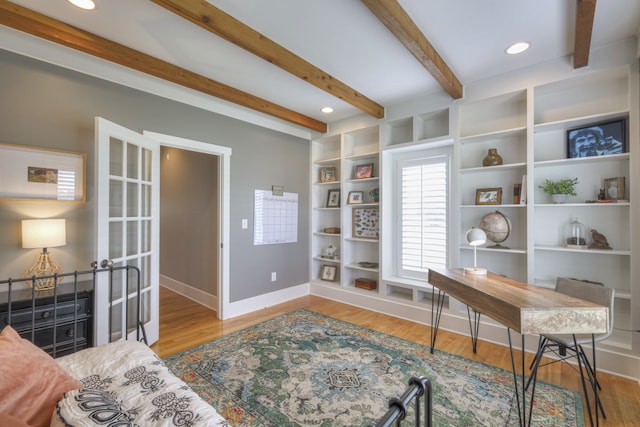 home office with beamed ceiling and light hardwood / wood-style flooring