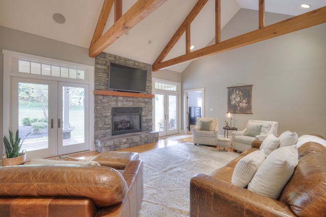 living room with a fireplace, high vaulted ceiling, french doors, and a wealth of natural light