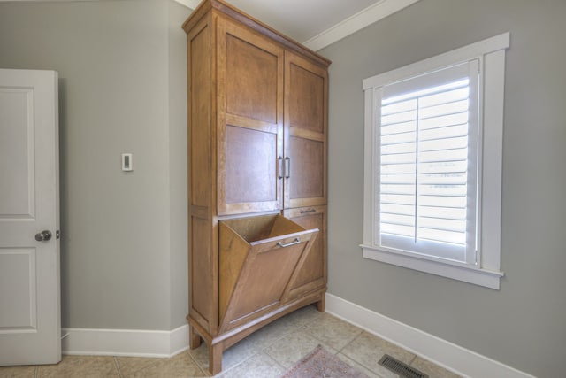 washroom with light tile patterned flooring and crown molding