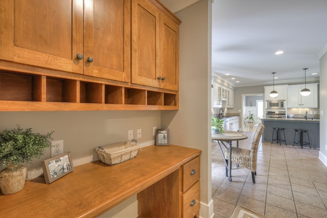 interior space featuring sink and crown molding