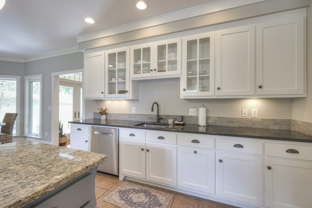 kitchen with stainless steel dishwasher, white cabinetry, and sink