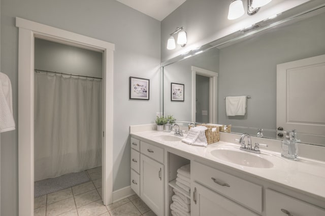 bathroom with a shower with curtain, vanity, and tile patterned floors