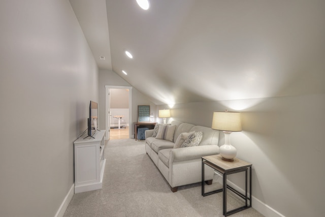 carpeted living room with vaulted ceiling