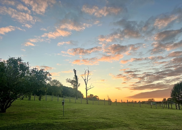 yard at dusk with a rural view