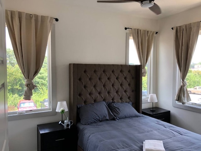 bedroom featuring multiple windows and ceiling fan