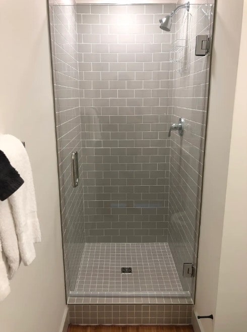 bathroom featuring a shower with shower door