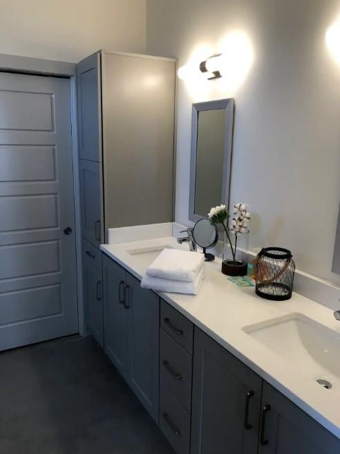 bathroom featuring double vanity and a sink
