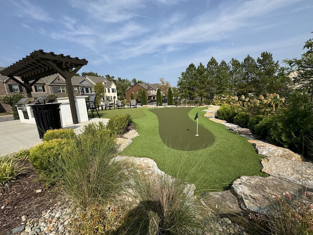 view of property's community with a pergola and an outdoor kitchen